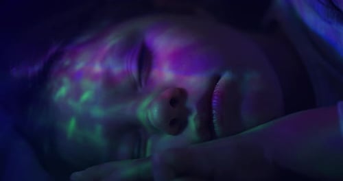 Woman Sleeping Peacefully with Colorful Lighting Effects