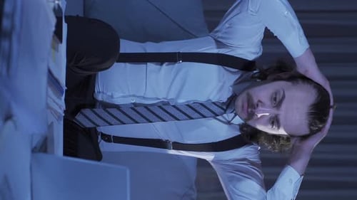 Tired Man Looking at His Phone Late at Night