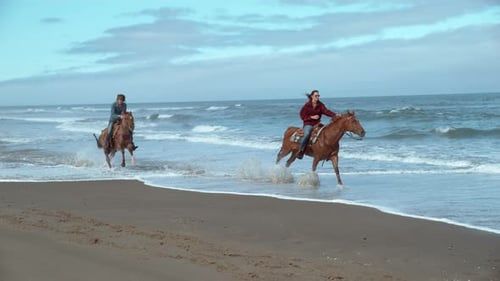 Women horseback riding on Oregon beach in super slow motion phantom flex 4k
