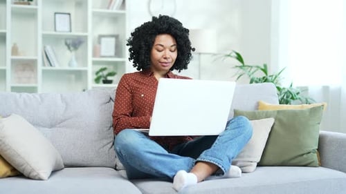 Woman Working on Laptop, Sitting on Couch