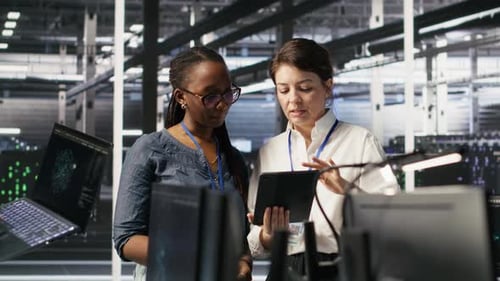 Data Center Teamworking Colleagues Performing Maintenance on Server Racks