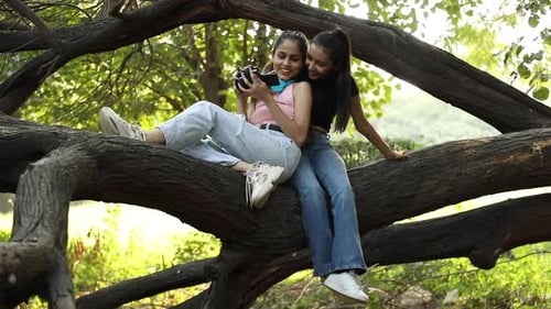 Two Happy Friends Posing With Camera in Park