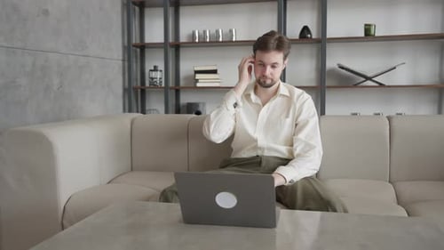 Young Adult Working on Laptop at Home