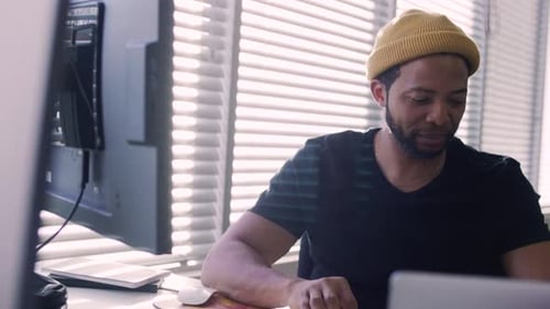 Smiling Creative Businessman Using Computer Working in Office 4044 Years