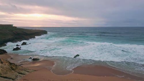 Sunrise Glowing Ocean Landscape with Waves Caressing Sandy Coast Sandy Beach