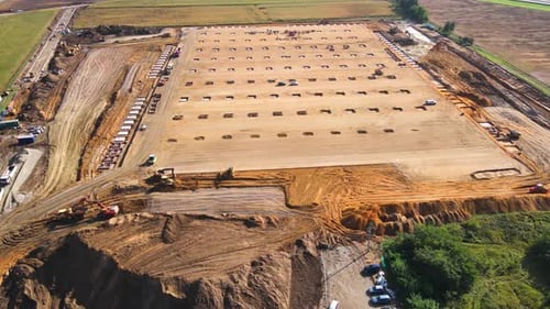 Aerial view of construction site with foundation works and machinery
