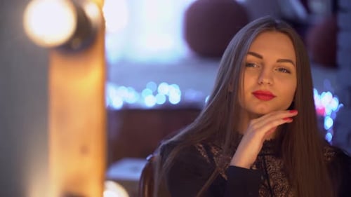 Beautiful Woman Posing with Red Lipstick in Dark Room