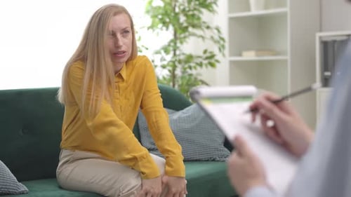 Woman Talking During Therapy Session in Bright Room