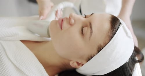 Woman Receives Cosmetic Facial Treatment at Spa