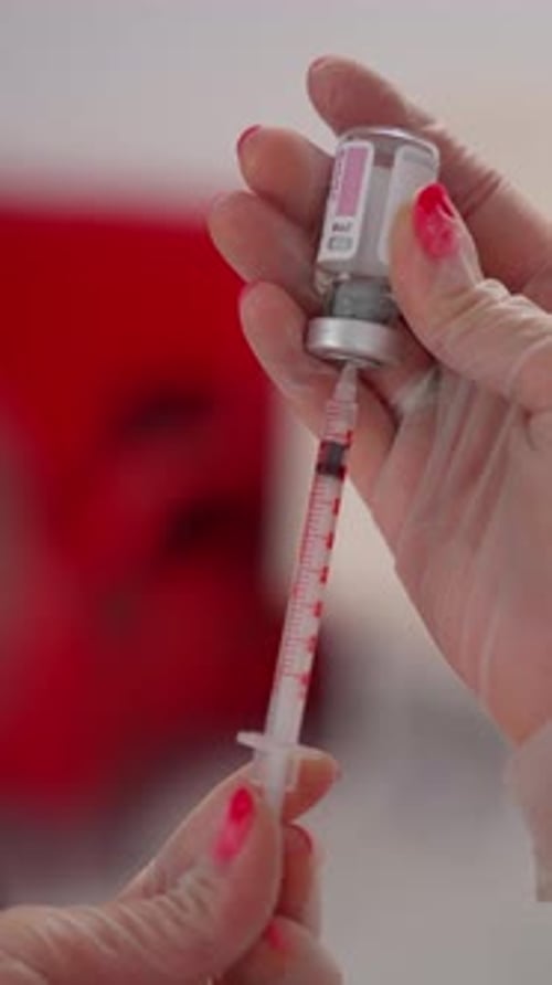 Drawing Liquid from Vial into Syringe Close Up