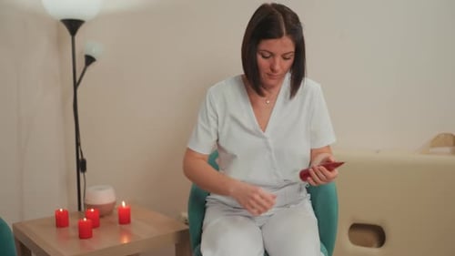 Woman Applies Lotion in Relaxing Spa Setting