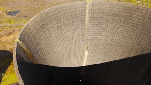 Close Overhead Cooling Tower Interior with Curved Walls Vertical Pipe and Light Opening Concrete