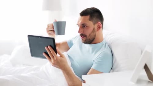 Man in Bed Video Chatting Tablet Morning