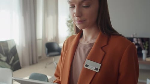 Customer Service Associate Working on Digital Tablet in Furniture Store