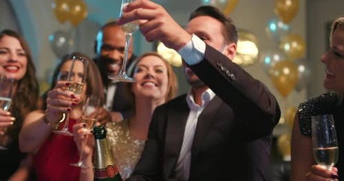 Young Adults Toasting Champagne at Birthday Party