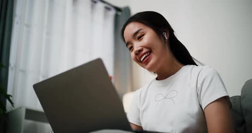 Woman Laughing During Video Chat at Home
