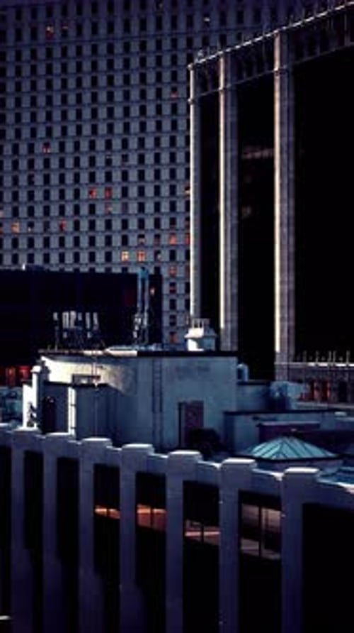 Twilight City Skyline with Glimmering Windows and Architectural Details