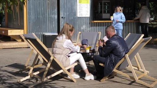 Family at outdoor cafe on a sunny day
