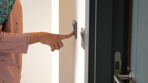 Finger Presses Doorbell Button Inside Home