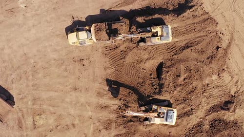 Aerial View of Excavators Loading Soil into Trucks