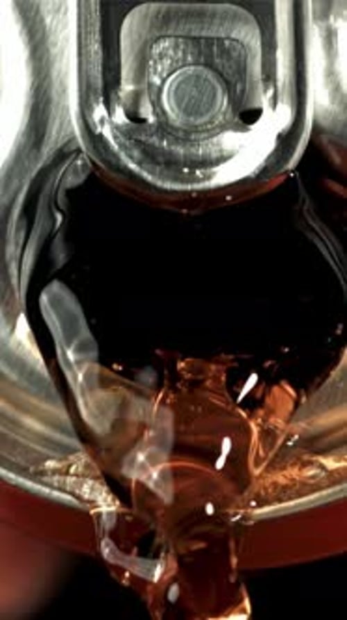 Cola Pours From a Tin Can
