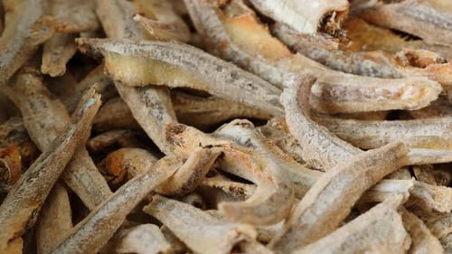 Dry Salty Fish Anchovies on a Plate Closeup Dried Fish Snack for Beer Party at the Cafe or Bar