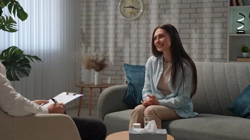 Woman Speaking To Therapist In Office