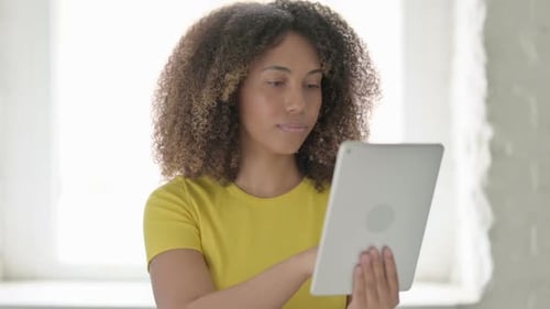African Woman using Tablet in Office
