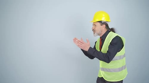 Engineer looking at camera in amazement and making a presentation.