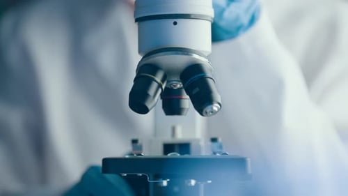 Close Up of Microscope in Lab with Gloves