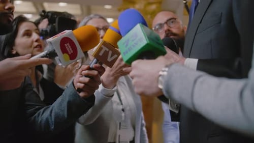 Busy Press Conference with a Subject Giving Speech