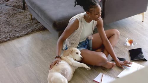 Woman Works At Home with Her Labrador Dog