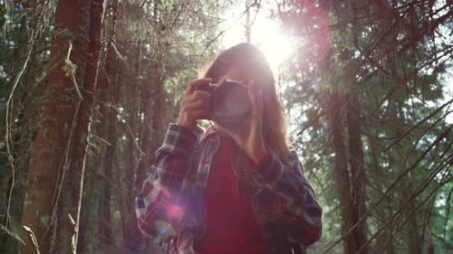 Portrait Of Attractive Woman Looking At Camera. Female Photographer Taking Photos Of Forest Lands...