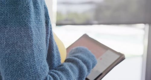 Woman Using Tablet in Modern Home