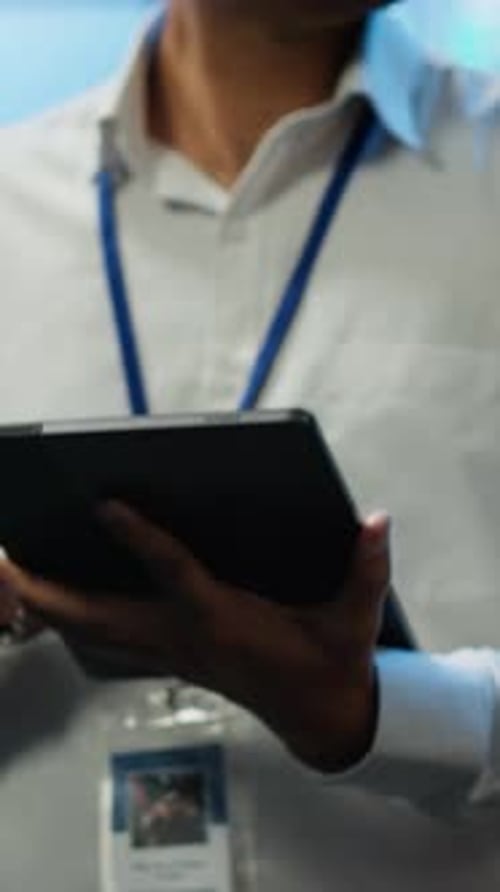 Man Holds Tablet in Office Environment