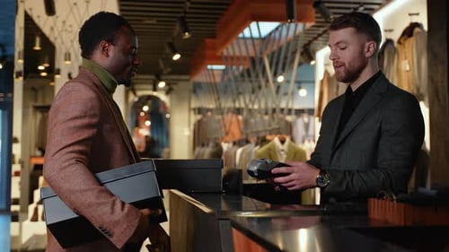 Black Man In Clothing Store Making Contactless Payment With Credit Card