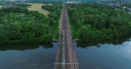 Top Aerial View of a Freight Train Moving Through a Beautiful Autumn Forest