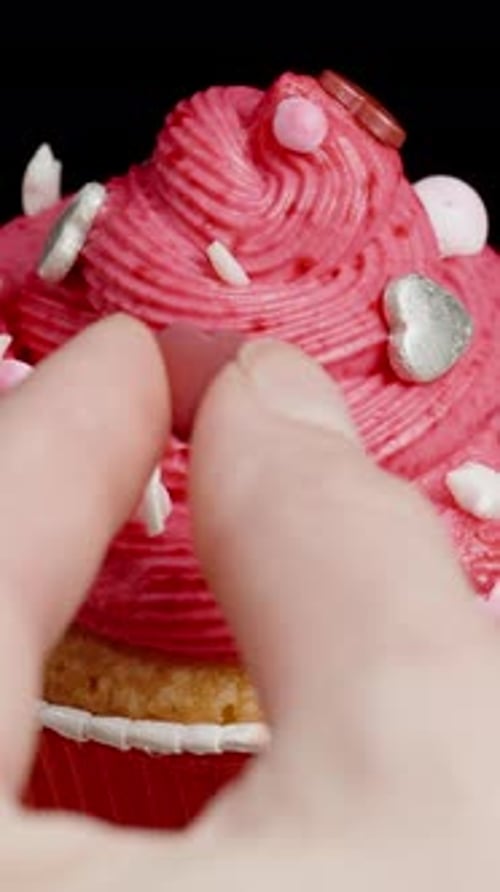 Decorating Pink Frosting Cupcake with Heart Shaped Candies