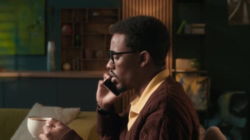 Man Talking on Cell Phone at Home