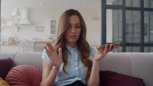 Focused businesswoman speaking on smartphone at home office in slow motion
