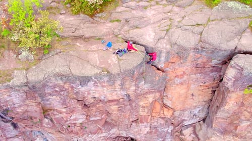 Rock Climbers Climb Down Rocky Cliff, Aerial Drone Shot 4k