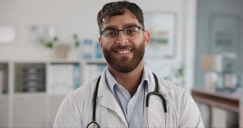 Face, male doctor and smile for healthcare, service and advice as medical professional in hospital