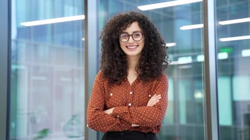 Smiling young woman poses in modern office