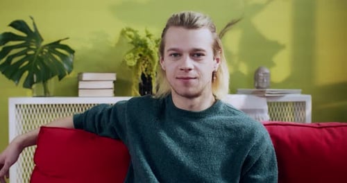 Portrait of Attractive Joyful Blonde Hipster Resting at Home Confident Young Casual Man Sitting on