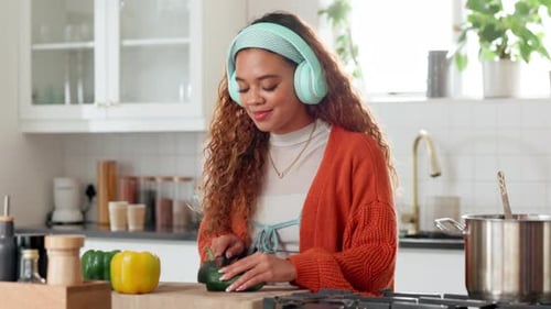 Young Woman Cooking Vegetables in a Bright Kitchen