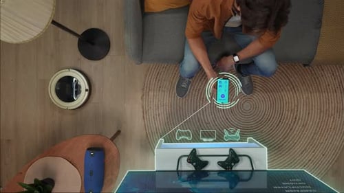 Top View of Man Sitting on the Sofa Switching on Tv Cleaner Lights and Music Speaker Using App on