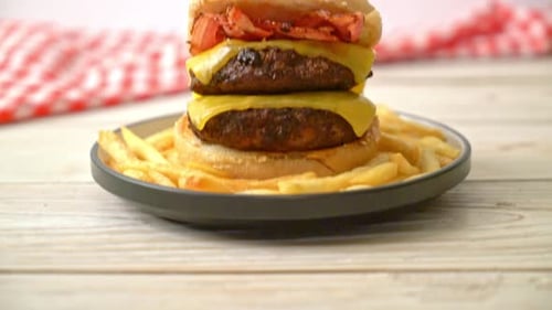 Double Cheeseburger with Bacon and Fries on Plate