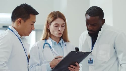 Multirace Group of Hospital Staff Negotiating in the Hallway Diverse Specialist Doctor and Assistant