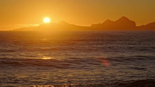 Sunrise Over Stormy Sea Shining Golden Waves with Sun Reflection at Sunset