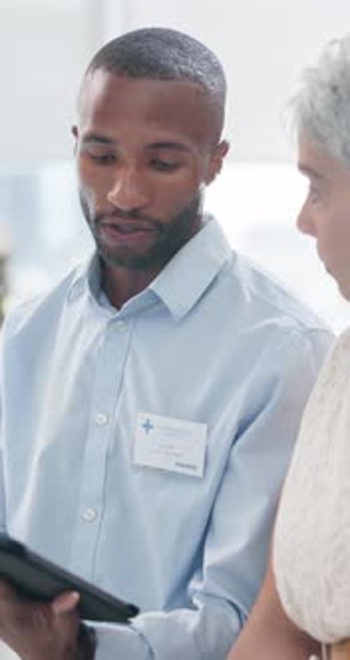 Medical Professional Consults with Patient Using Tablet